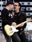 Lead singer Bono (R) and the Edge of Irish rock band U2 perform during concert at the City of Manchester Stadium June 14, 2005. U2 are currently on their 'Vertigo 2005' world tour. REUTERS/Darren Staples