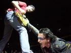 SHARON CANTILLON/Buffalo News U2's Bono gets into some stage theatrics with the Edge, left, in HSBC Arena.
