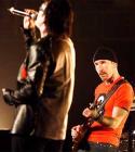 Bono (left) sings 