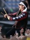 Lead singer Bono of Irish rock band U2 performs during a concert at the City of Manchester Stadium, northern England, June 14, 2005. U2 are currently on their 'Vertigo 2005' world tour. REUTERS/Darren Staples