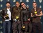 U2, from left, The Edge, Adam Clayton, Bono and Larry Mullen hold the Grammys they won at the 44th annual Grammy Awards, Wednesday, Feb. 27, 2002, in Los Angeles. U2 won for best rock performance, record of the year, best rock album and best pop performance by a duo or group. (AP Photo/Reed Saxon)