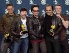 U2, from left, Adam Clayton, The Edge, Bono and Larry Mullen, far right, pose with producer Daniel Lanois, second right, at the 44th annual Grammy Awards, Wednesday, Feb. 27, 2002, in Los Angeles. U2 won Grammys for best rock performance, record of the year, best rock album and best pop performance by a duo or group. (AP Photo/Reed Saxon)